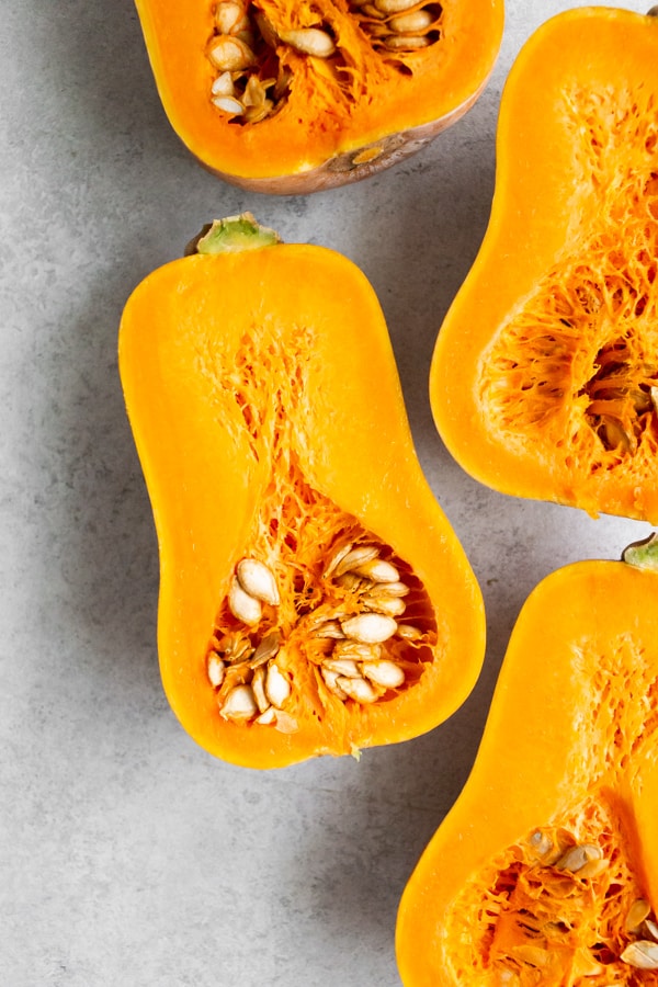 cut in half honeynut squash showing seeds.