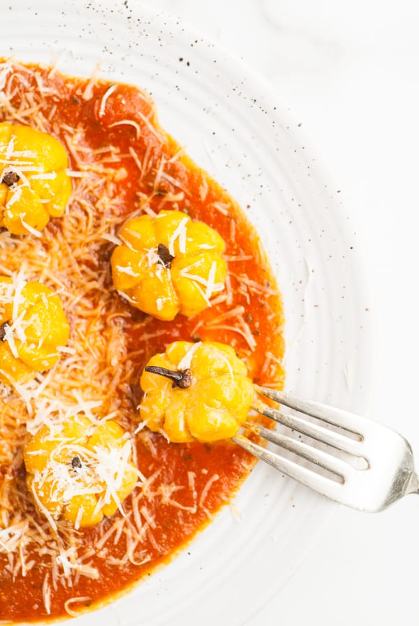 Pumpkin Shaped Gnocchi on a plate with a fork. 