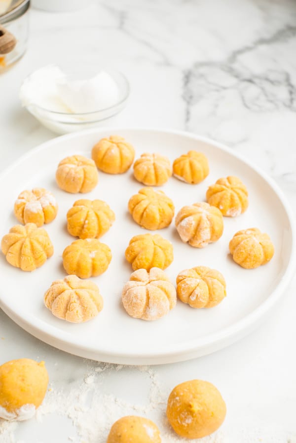 Balls of gnocchi shaped like little pumpkins. 