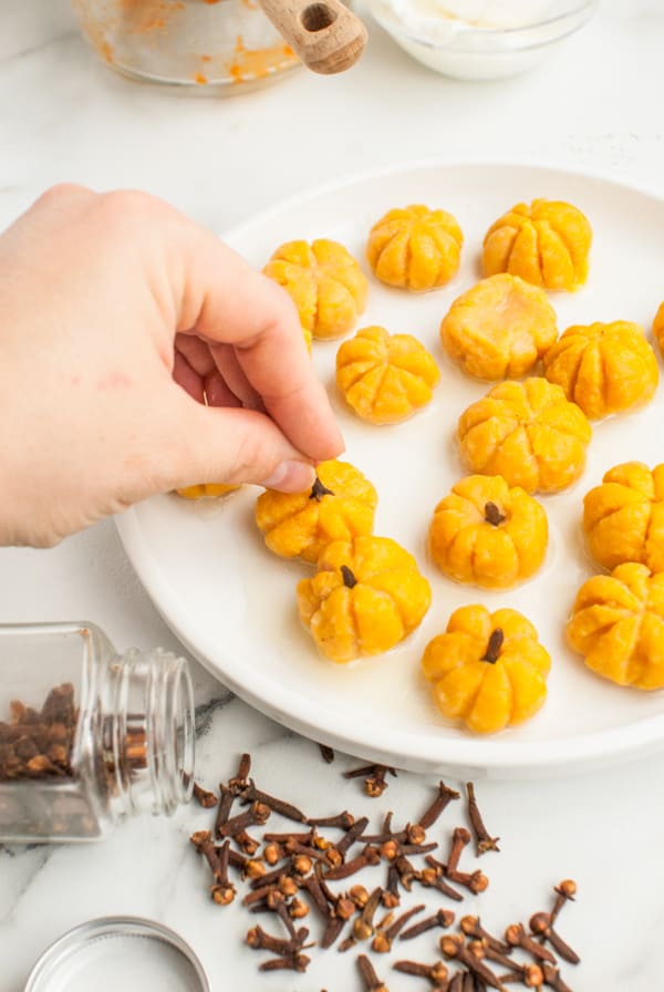 Pumpkin Shaped Gnocchi cooked and getting cloves put in for the stems. 