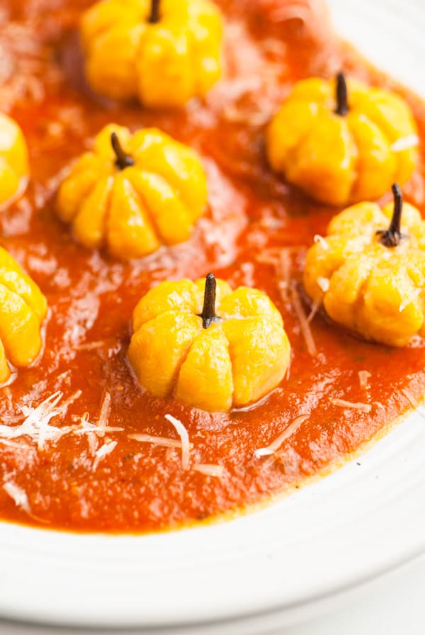 Pumpkin Shaped Gnocchi sitting in red sauce. 