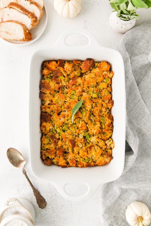 Sage and Cornbread Stuffing in white casserole dish. 