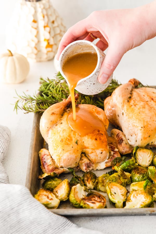 Sheet Pan Thanksgiving Dinner on a platter getting covered in gravy.