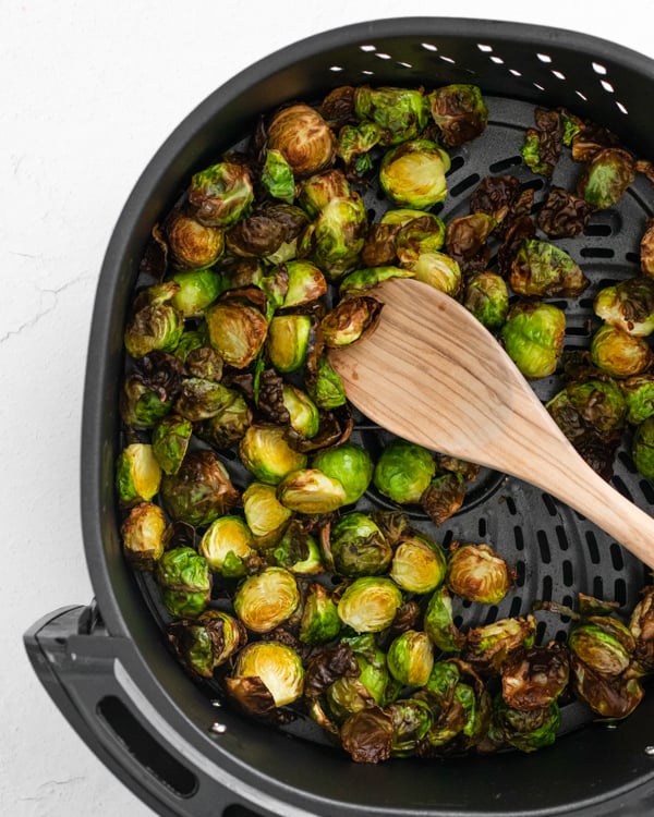 Air Fryer Brussels Sprouts sitting in the air fryer basket. 