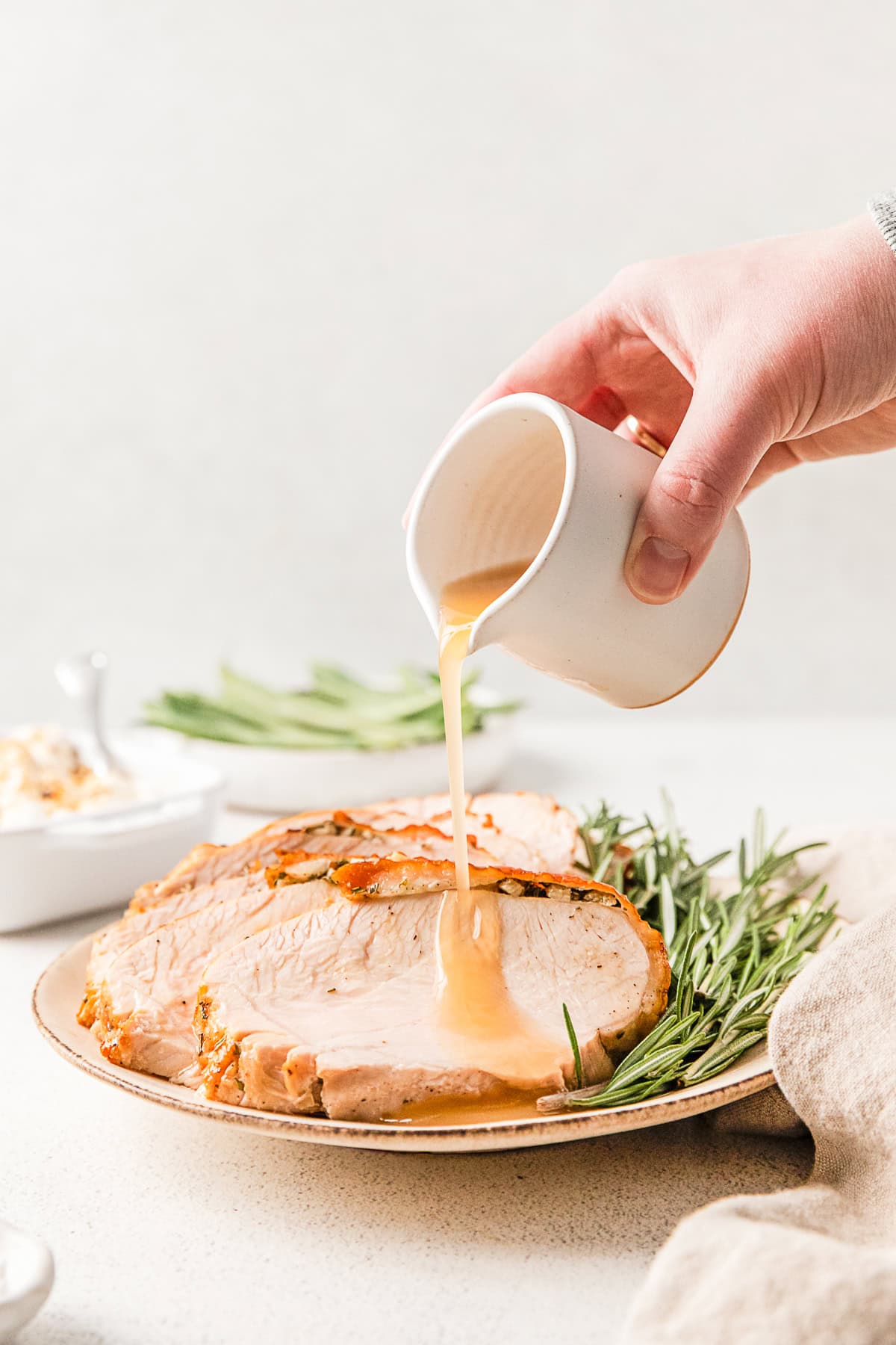 Pouring gravy on Air Fryer Turkey Breast.