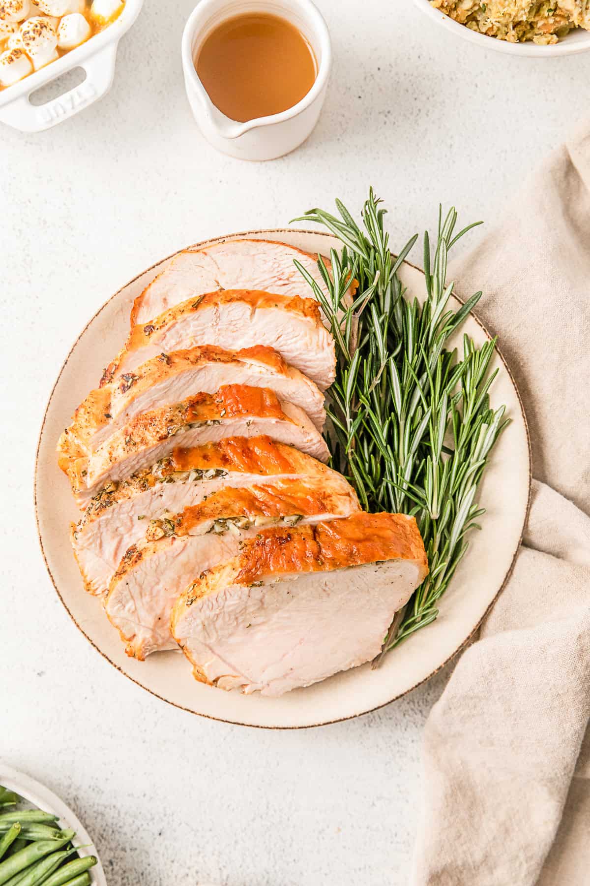 Air Fryer Turkey Breast sliced on a white serving plate.