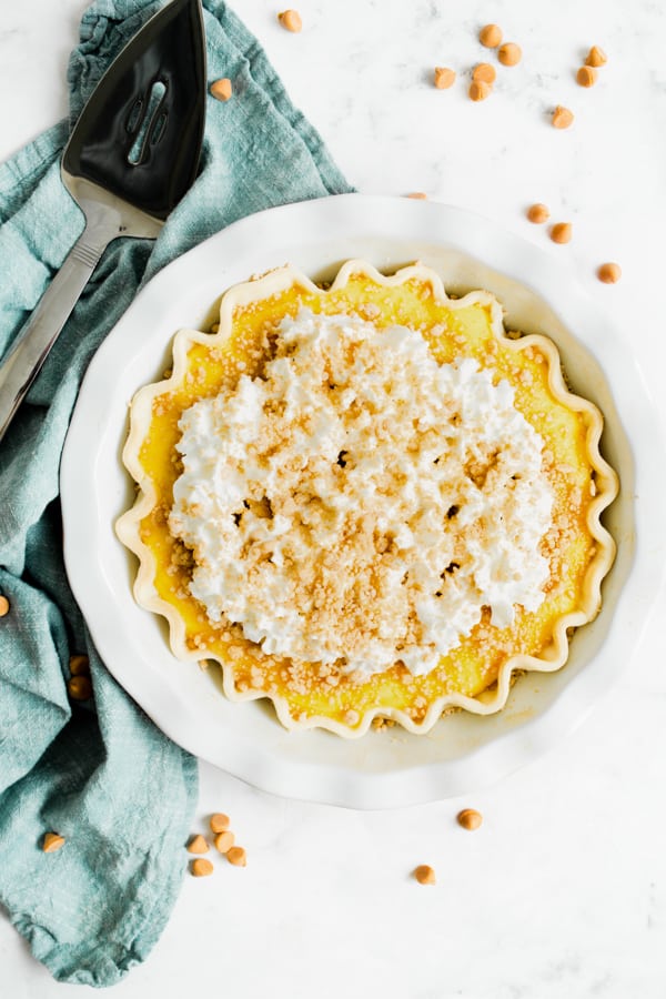 Amish Peanut Butter Pie in a pie dish topped withwhipped cream. 