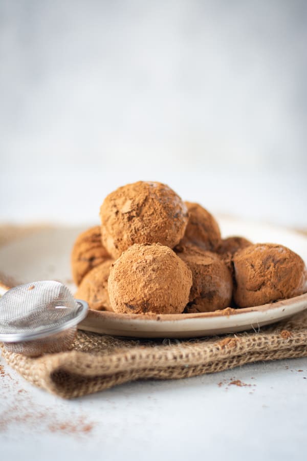 Classic Chocolate Truffles sitting on a plate. 