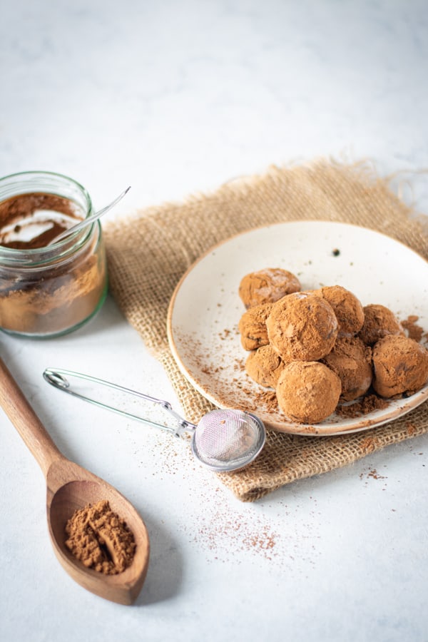 Classic Chocolate Truffles sitting on a white plate. 