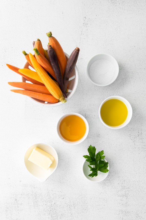 uncooked raw ingredients laid out to make Honey Roasted Carrots.