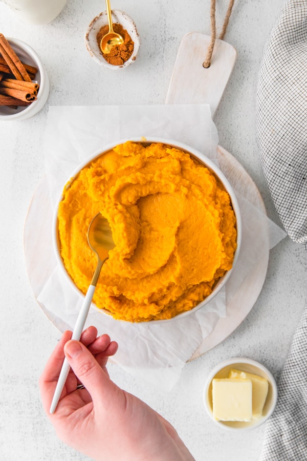 Scooping out a serving of Instant Pot Mashed Sweet Potatoes.