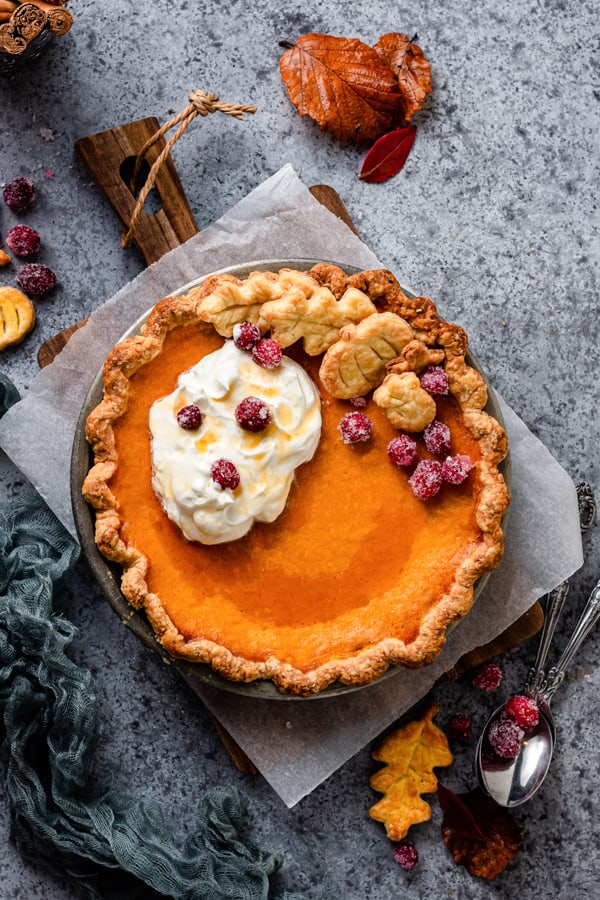 Pumpkin Cheesecake Pie served on a wooden serving platter.