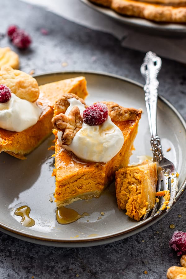 Pumpkin Cheesecake Pie slice with a bite taken out of it.