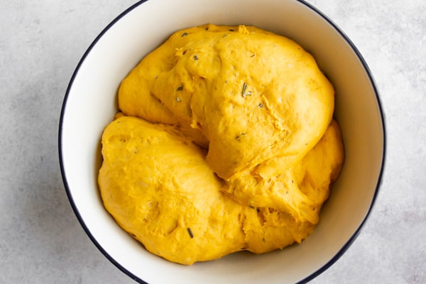 The dough for Rosemary Pumpkin Rolls in a bowl.