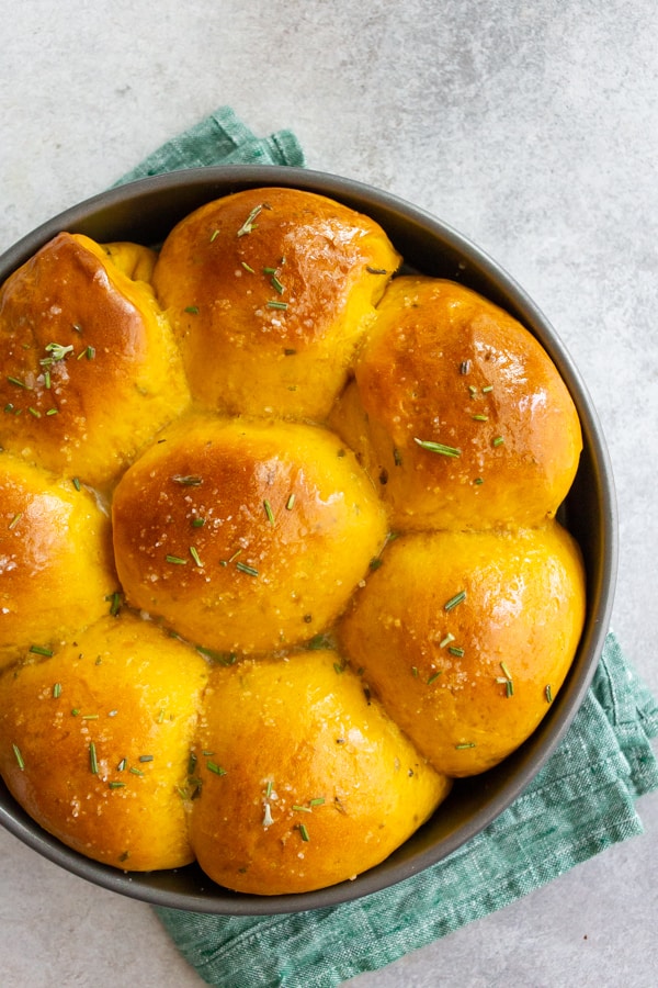 Rosemary Pumpkin Rolls in a round pan.