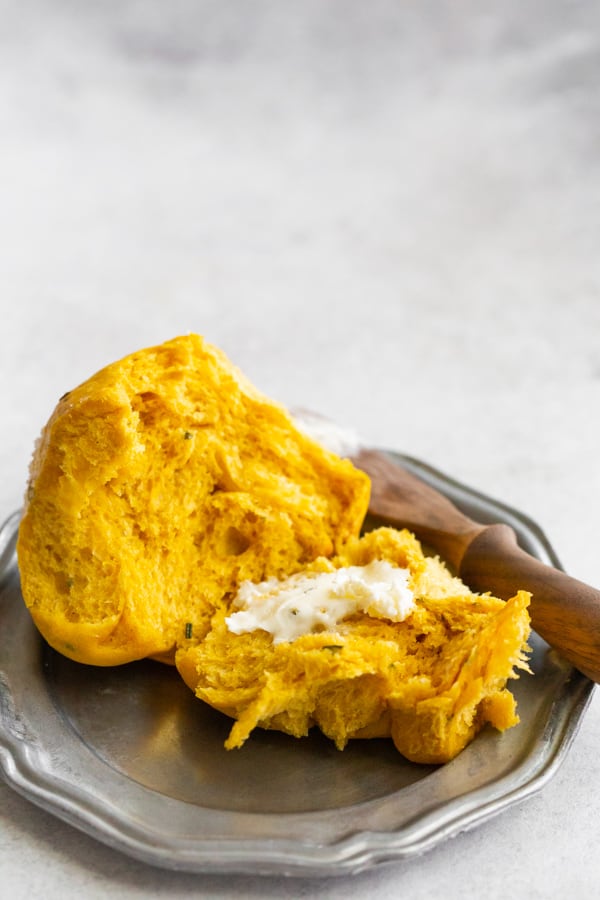 Rosemary Pumpkin Roll cut in half and spread with unsalted butter.