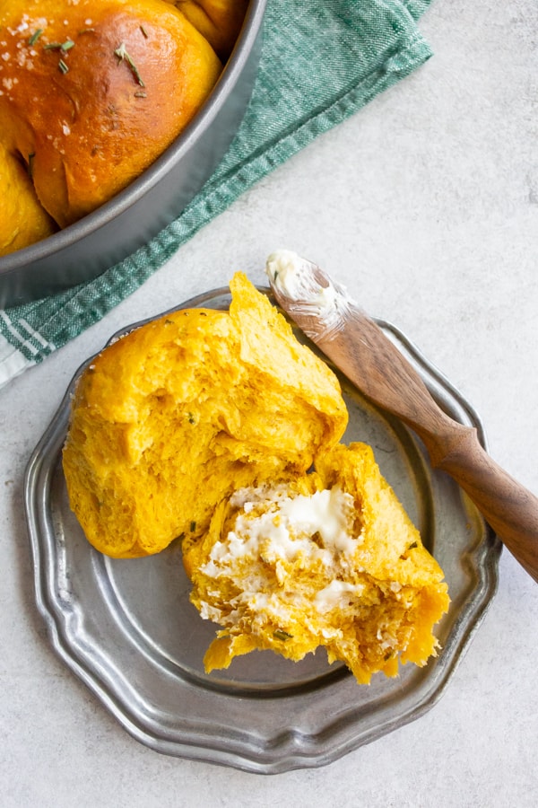 Rosemary Pumpkin Roll split in half and spread with butter.