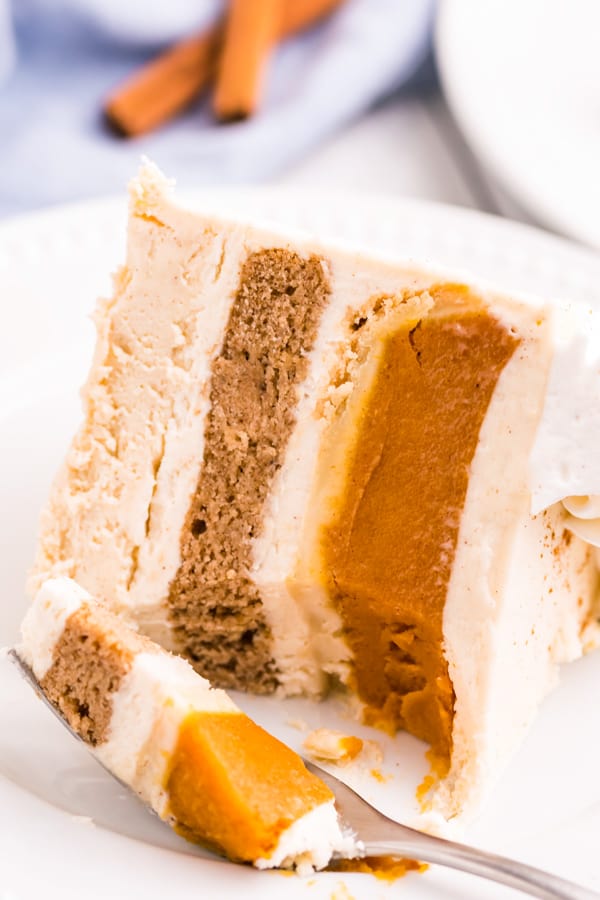 Thanksgiving Piecaken slice on a plate with. fork taking out a bite. 
