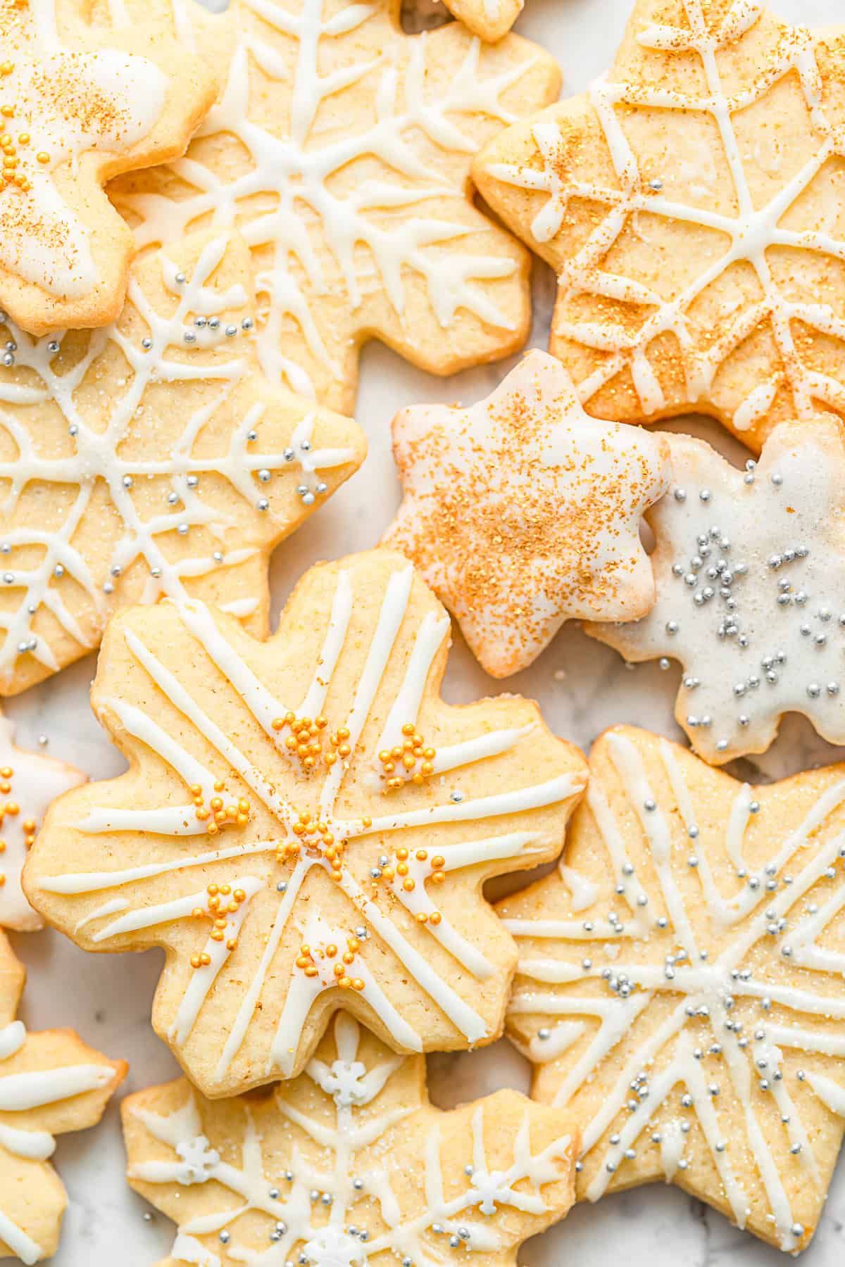 Almond Sugar Cookies decorated with royal icing and sprinkles.