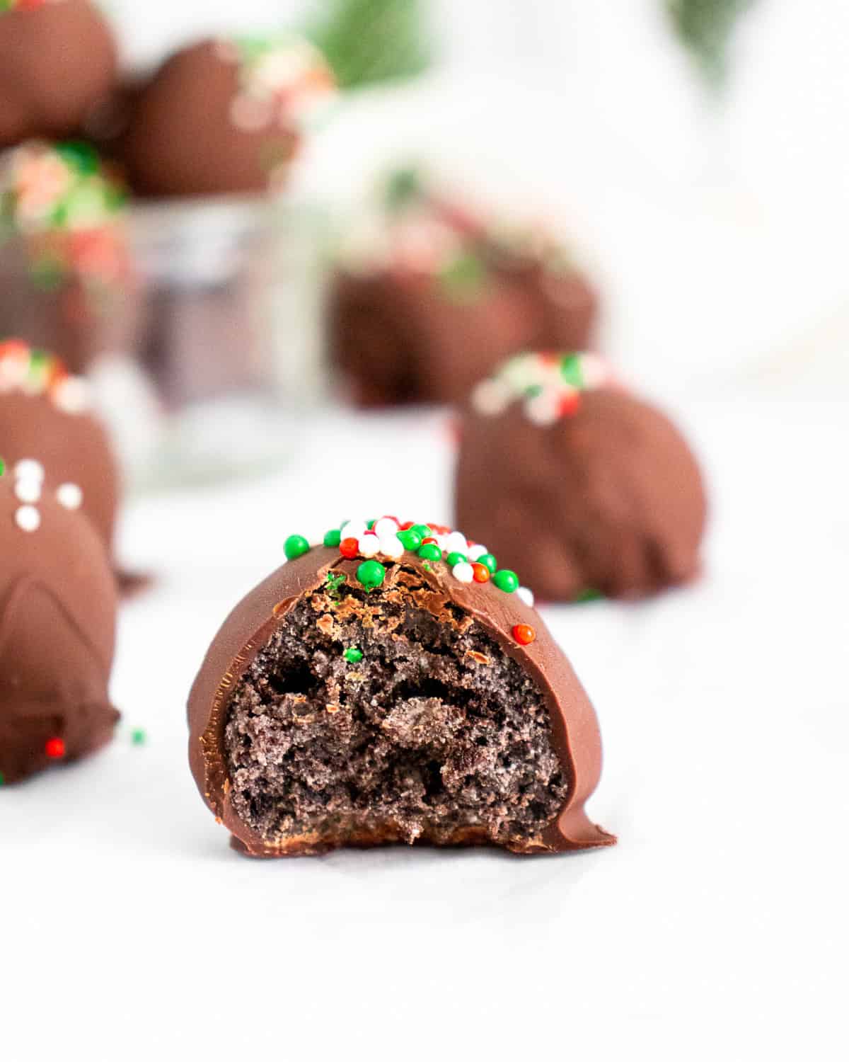 A bite take out of a Christmas Oreo Truffle.