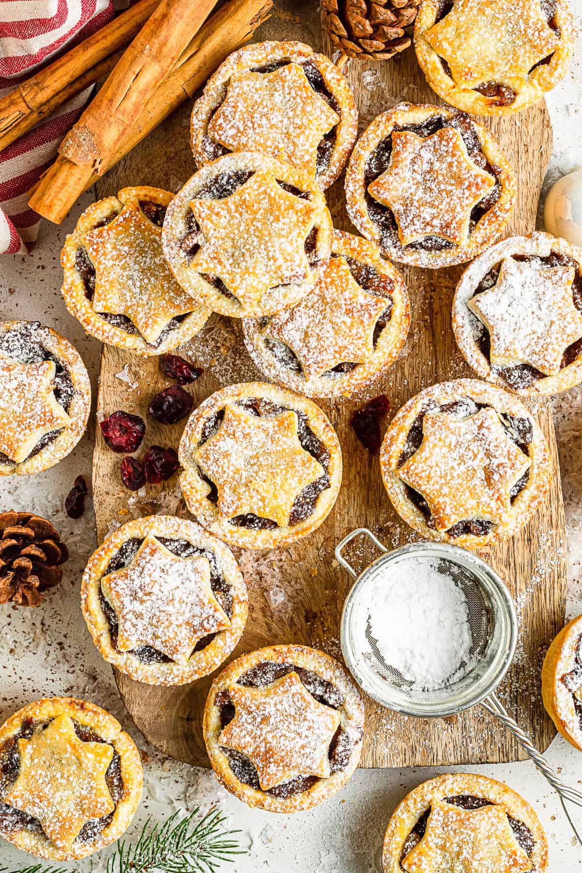 Mini Mincemeat Pies on a board with powdered sugar. 