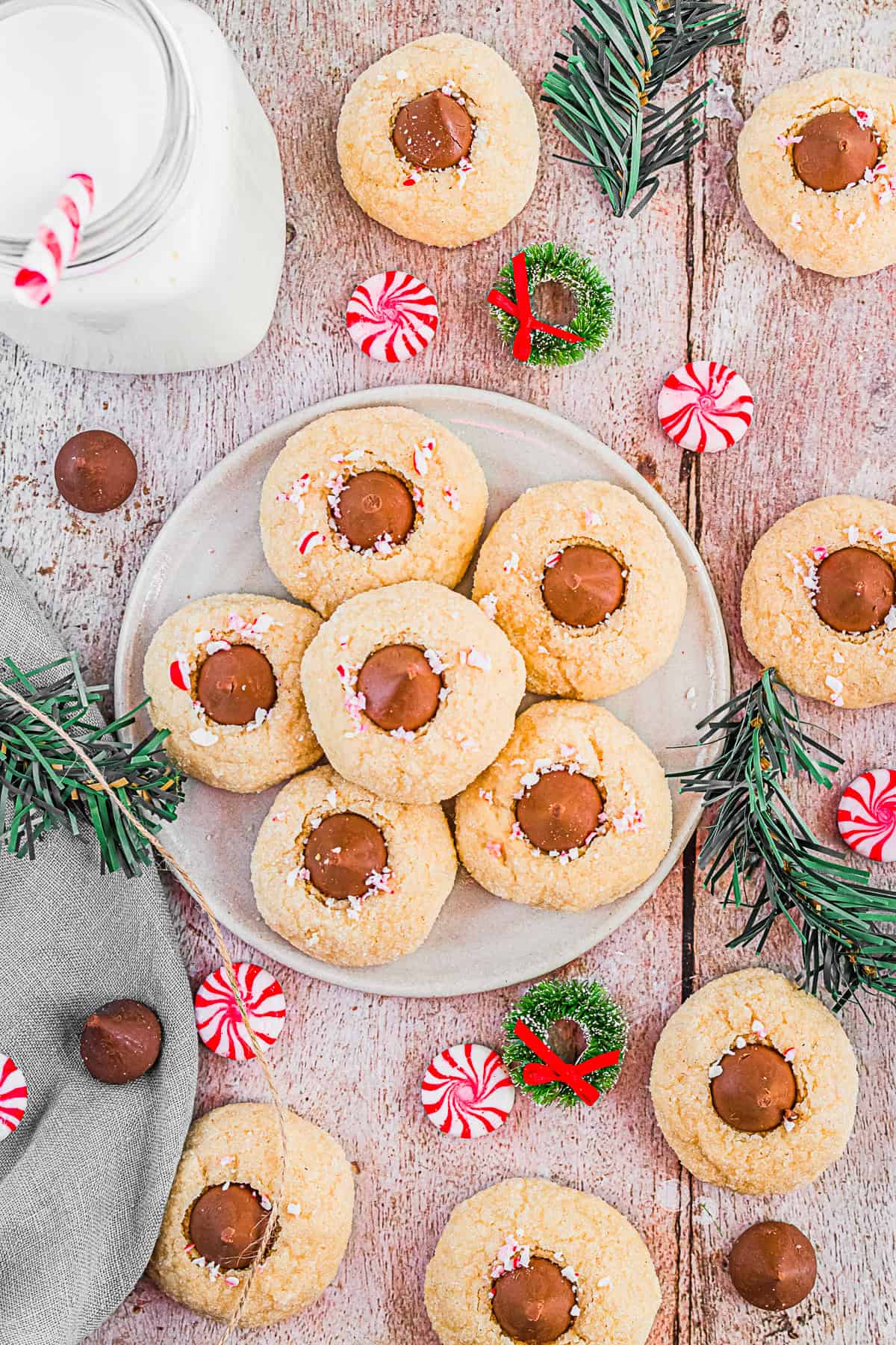 Peppermint Kiss Cookies on a plate with extra cookies around the plate. 