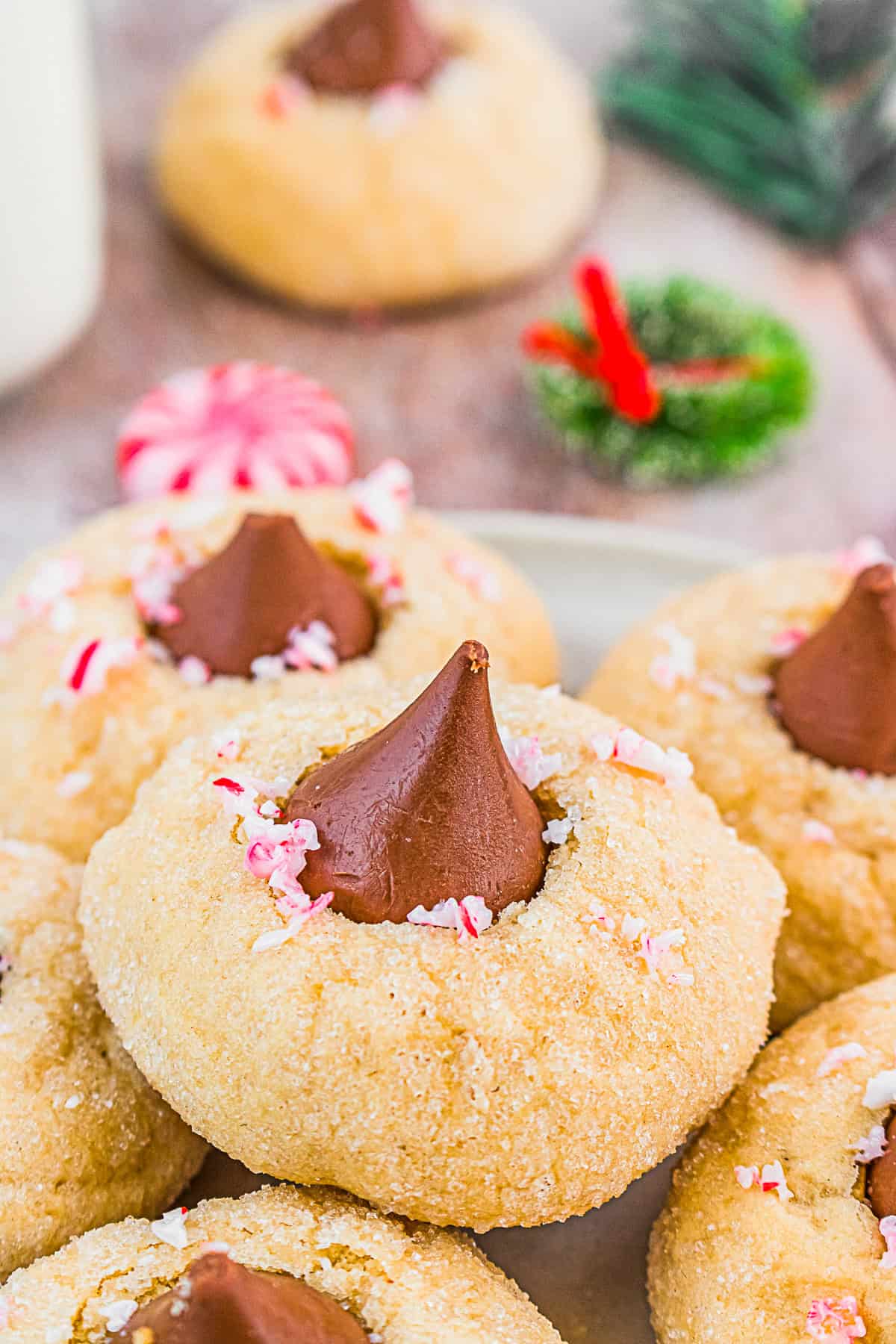 Peppermint Kiss Cookies on a plate sprinkled with crushed candy canes. 