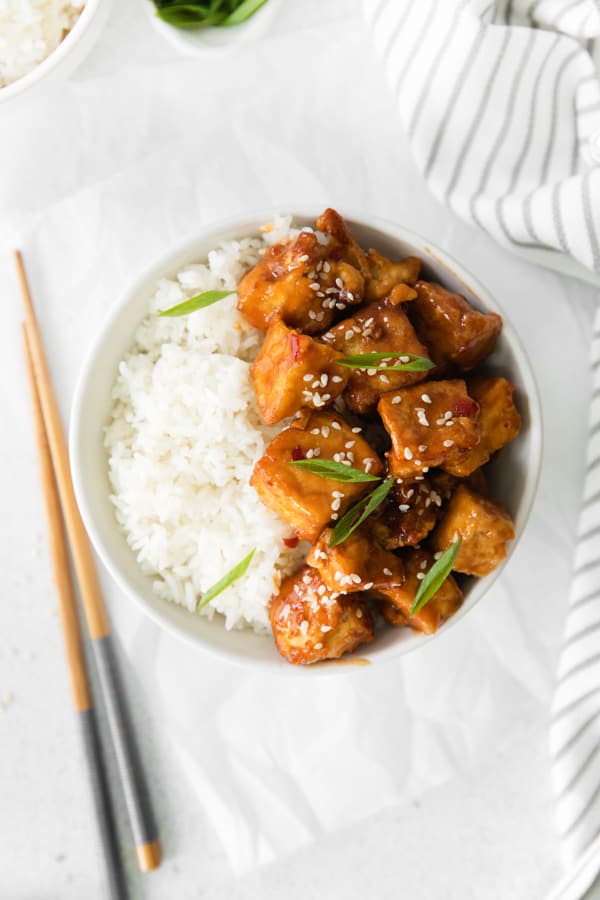 Air Fryer Sweet Chili Tofu in a white bowl with rice. 
