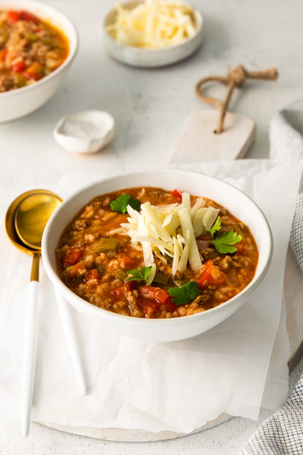 Instant Pot Stuffed Pepper Soup topped with shredded cheese.