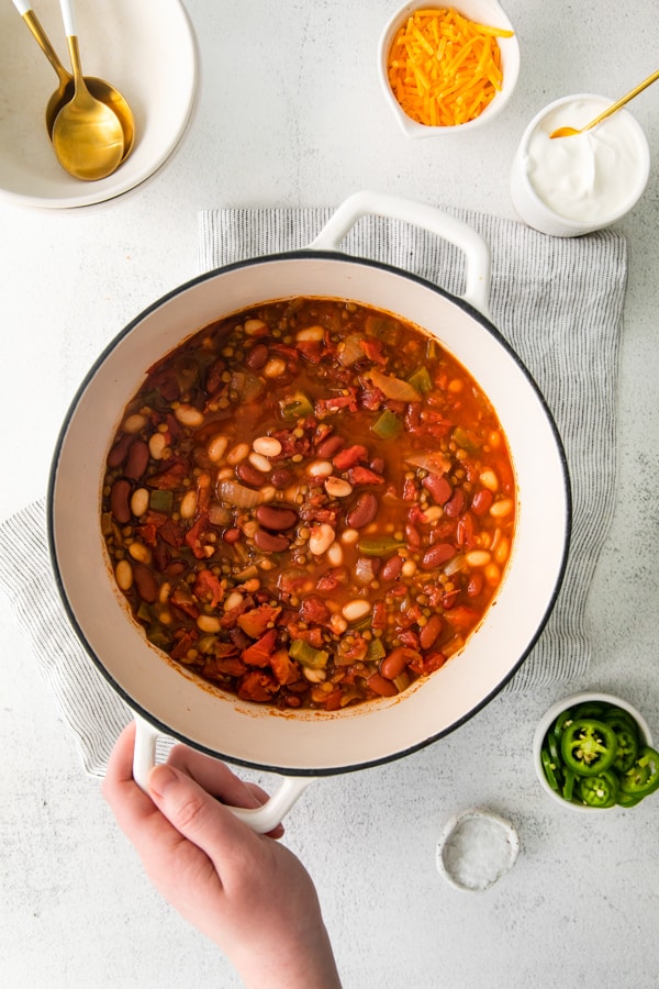 Vegan Lentil Chili in a large white dutch oven.