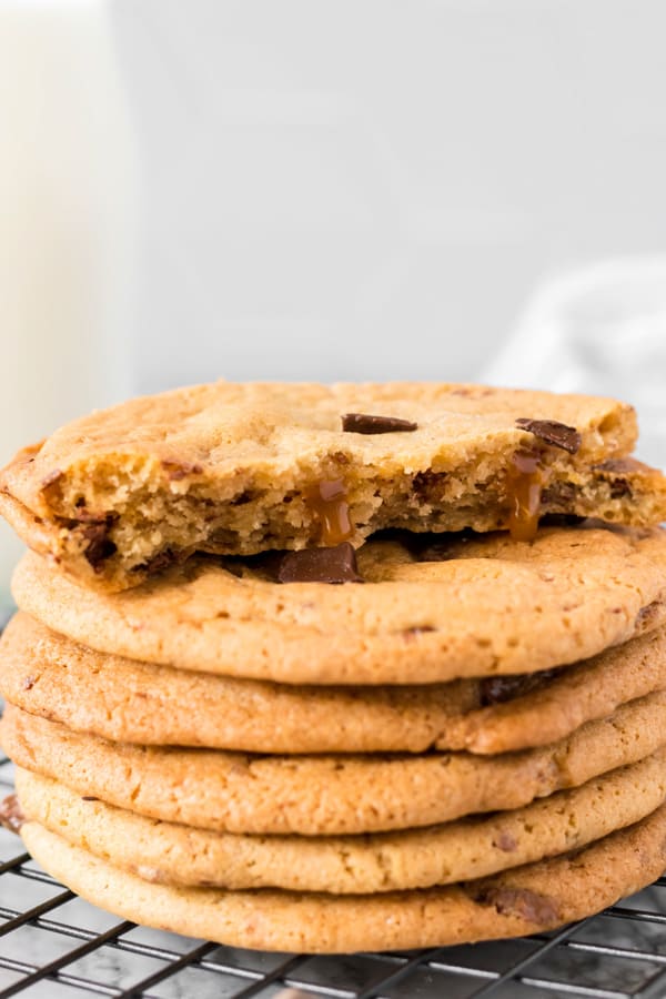 Caramel Chocolate Chip Cookies stacked on top of each other.