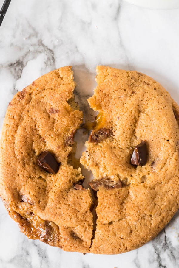 Caramel Chocolate Chip Cookies cut in half so you can see the caramel.
