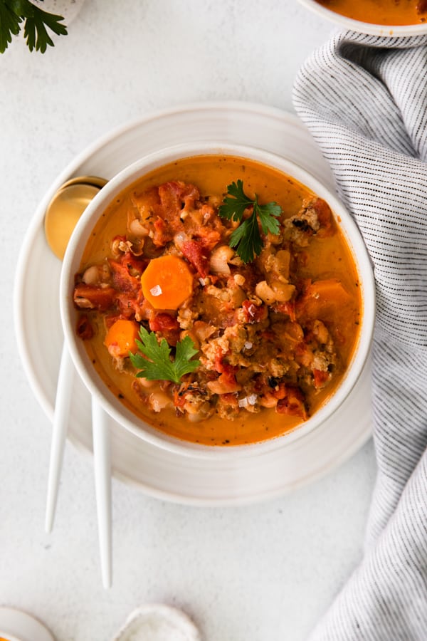 Instant Pot Ground Chicken Chili in a white bowl with a gold spoon. 