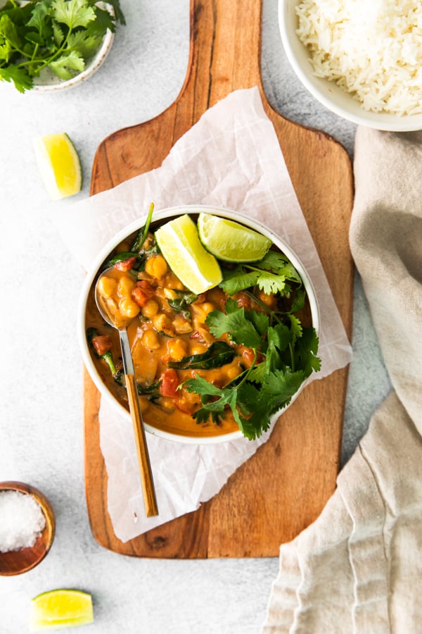 Vegan Chickpea Curry served in a bowl with cilantro and lime.