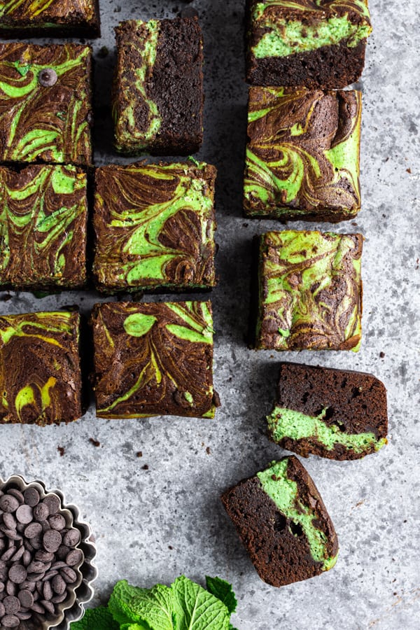 Swirled Mint Cream Cheese Brownies cut on a board. 