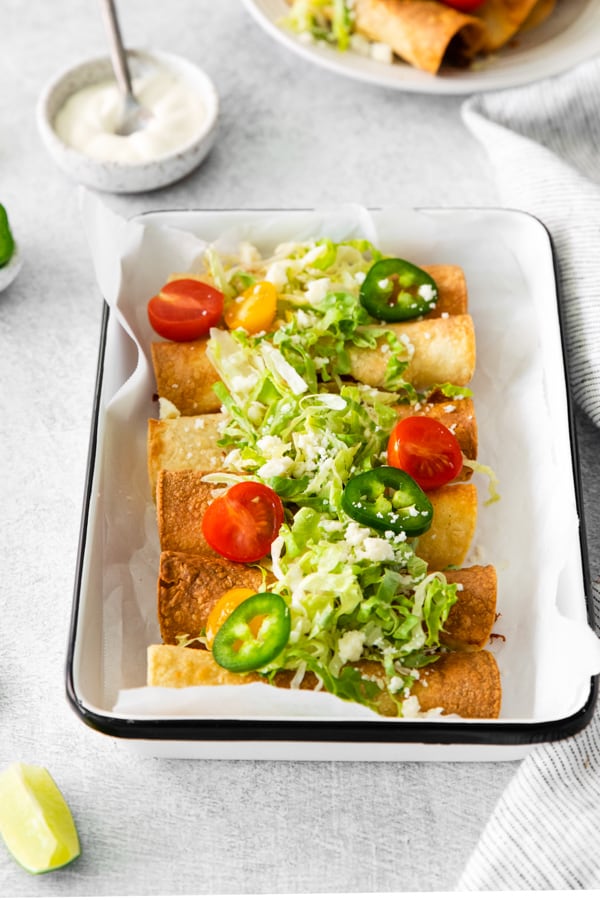 Air Fryer Chicken Taquitos served with lettuce.