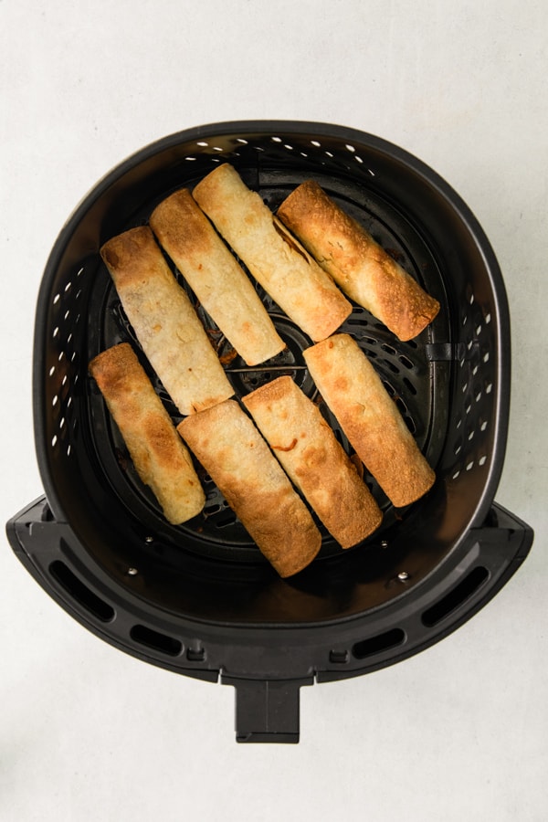 Air Fryer Chicken Taquitos in the air fryer basket.