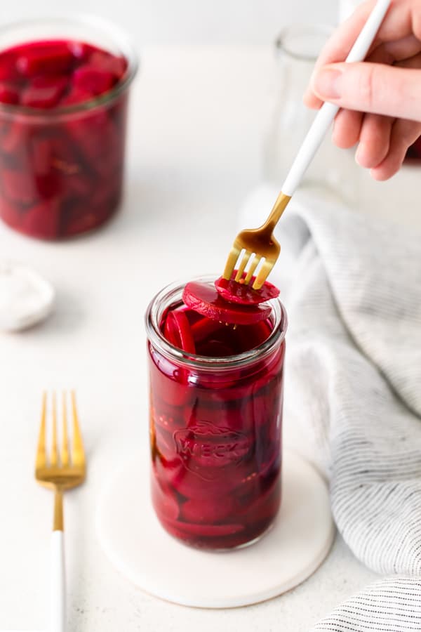 Quick Pickled Beets in a jar on a table.