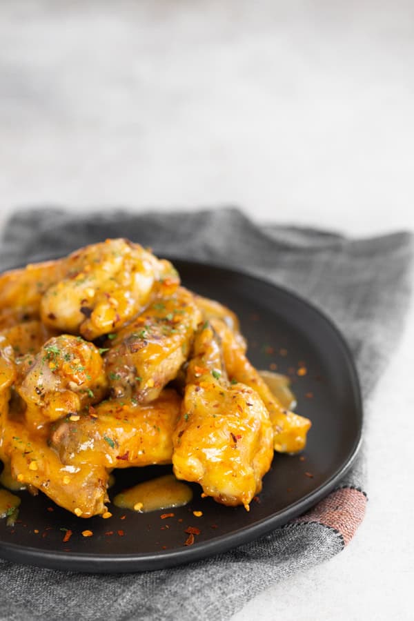 Air Fryer Honey Mustard Chicken Wings tossed in sauce.