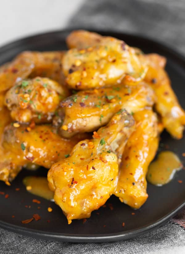 Air Fryer Honey Mustard Chicken Wings served on a black plate.