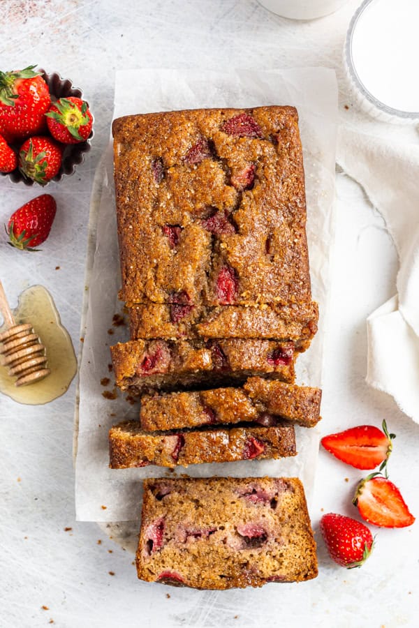 Fresh Strawberry Bread sliced on a serving board.