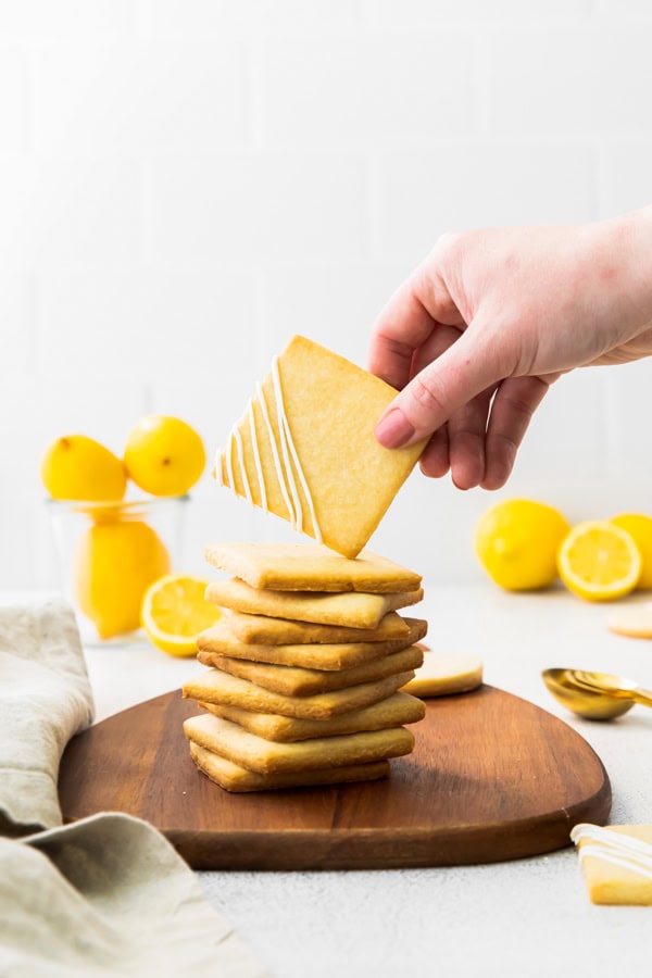 A hand picking up a Lemon Shortbread Cookie.