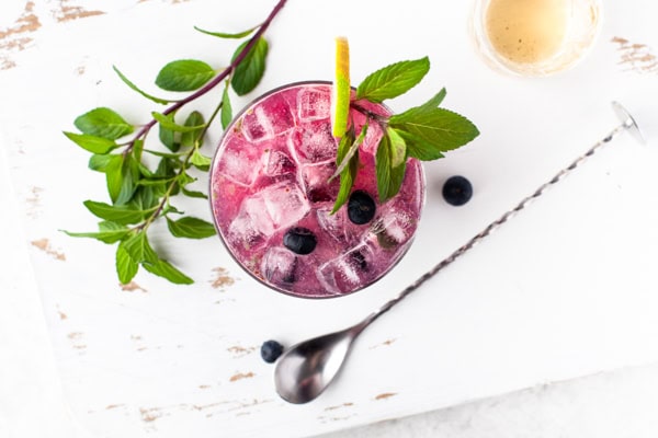Blueberry Mojito sitting on a table. 