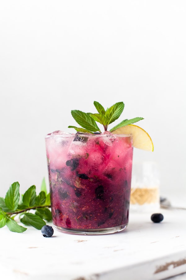 Blueberry Mojito sitting on a wooden ledge. 