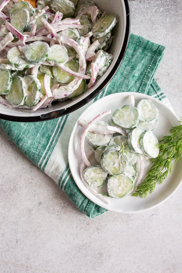Creamy Cucumber Salad on a white plate.