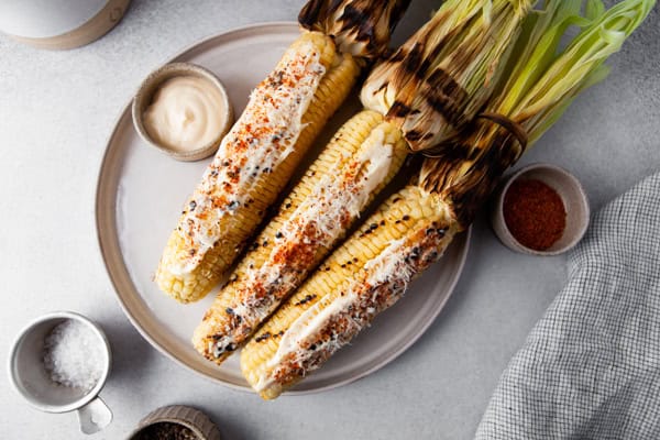 Grilled Mexican Corn served with extra spices. 