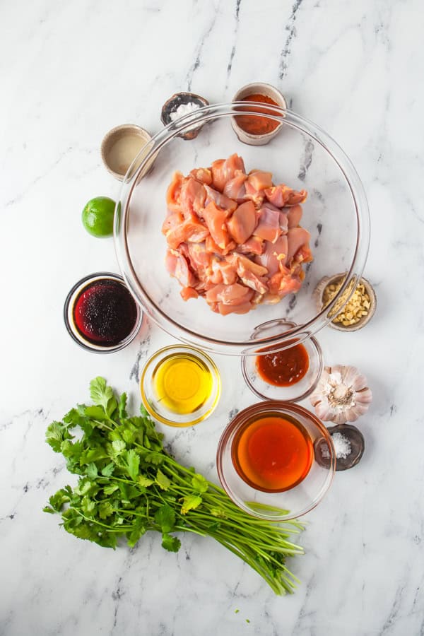 Ingredients to make Hot Honey Chicken Skewers sitting on a table. 