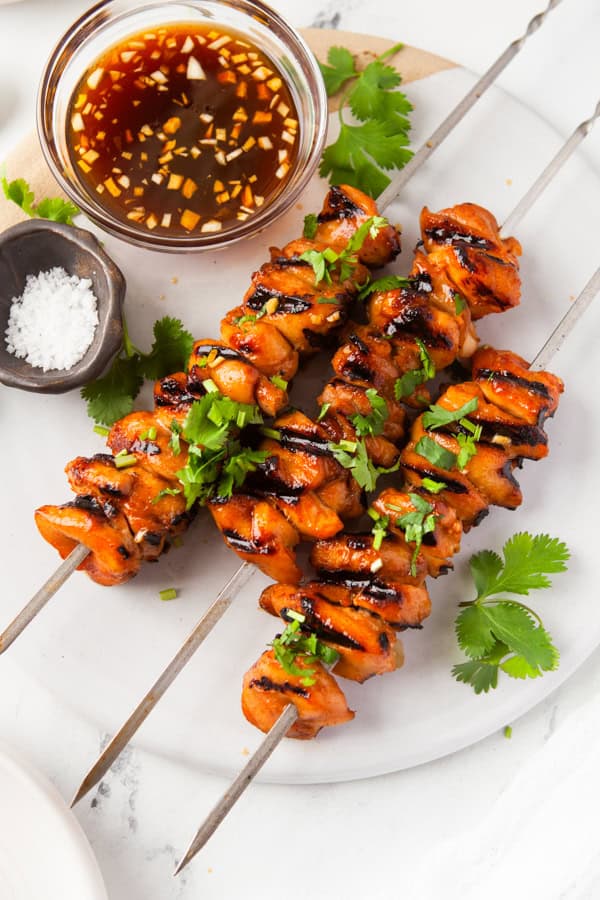 Hot Honey Chicken Skewers on a white platter. 