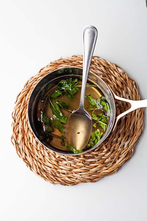 Mint Simple Syrup in a pan on a trivet.