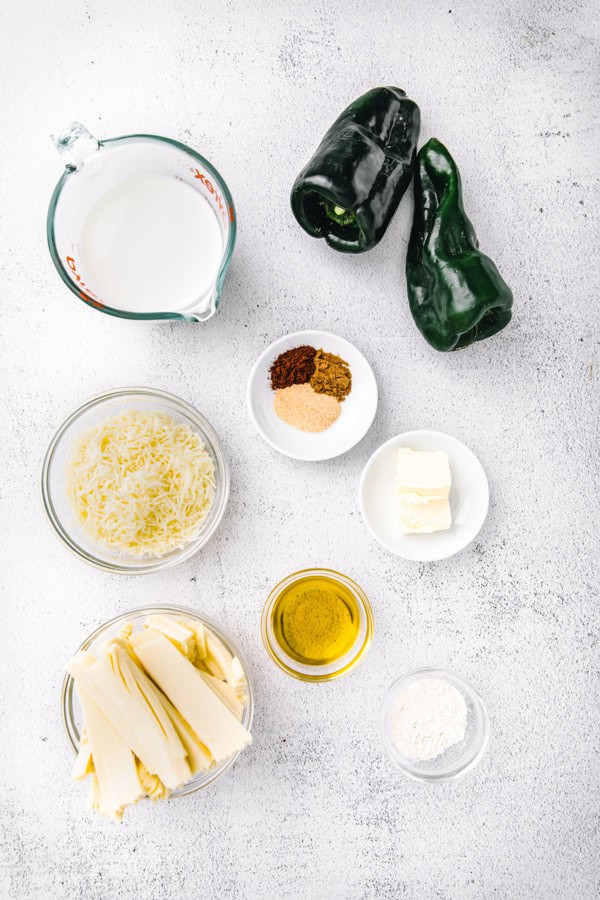 Ingredients to make Roasted Poblano Queso sitting on a table. 